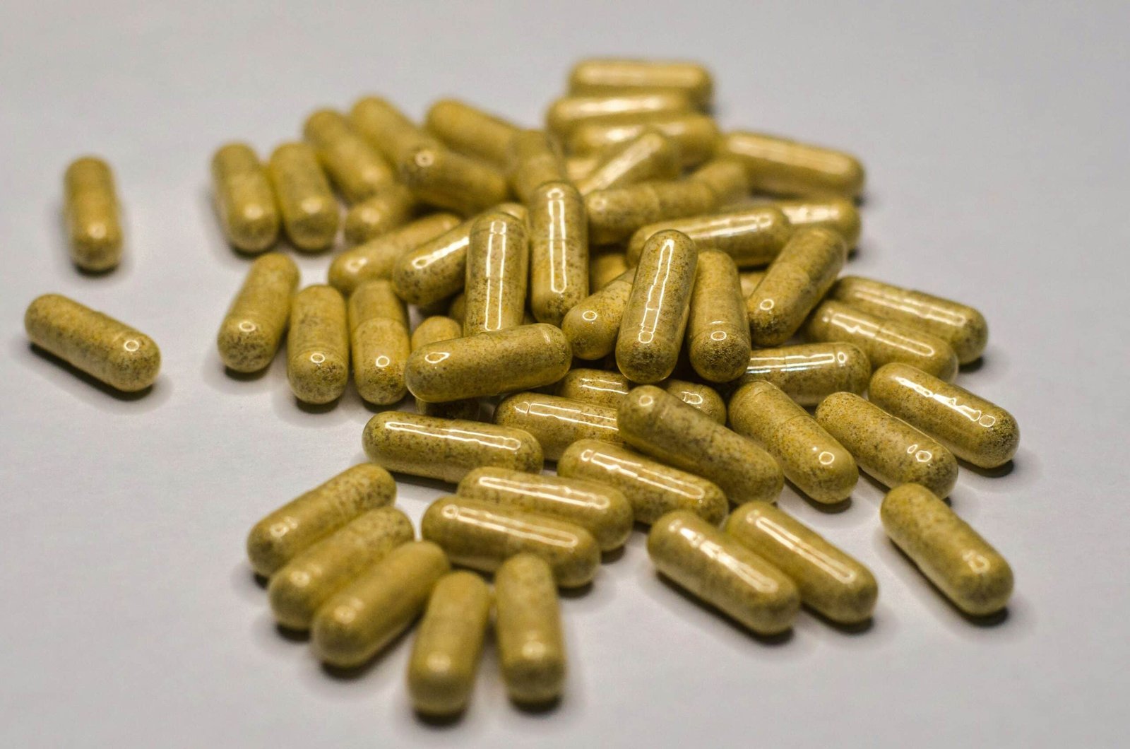 Yellow pills on a white surface
