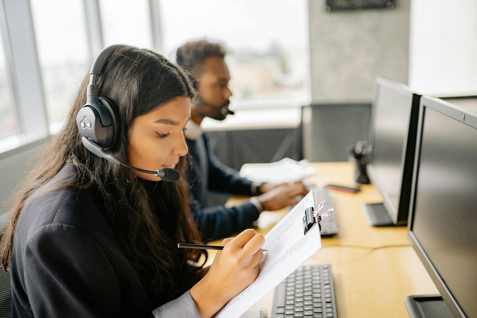 Focused customer support agents working at their desks, representing a Customer-First Business.