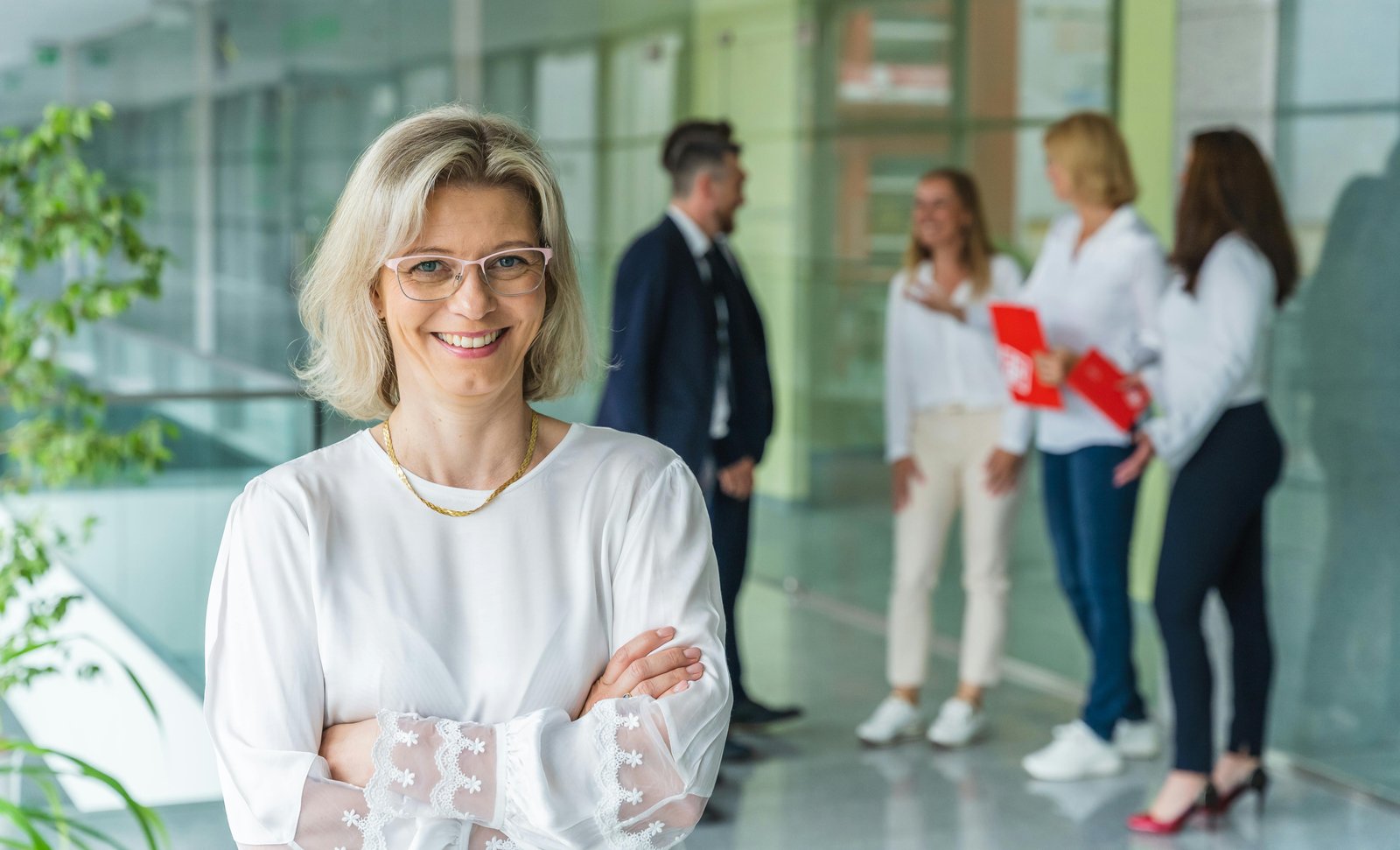 Smiling businesswoman representing fair and reasonable compensation in a professional setting.