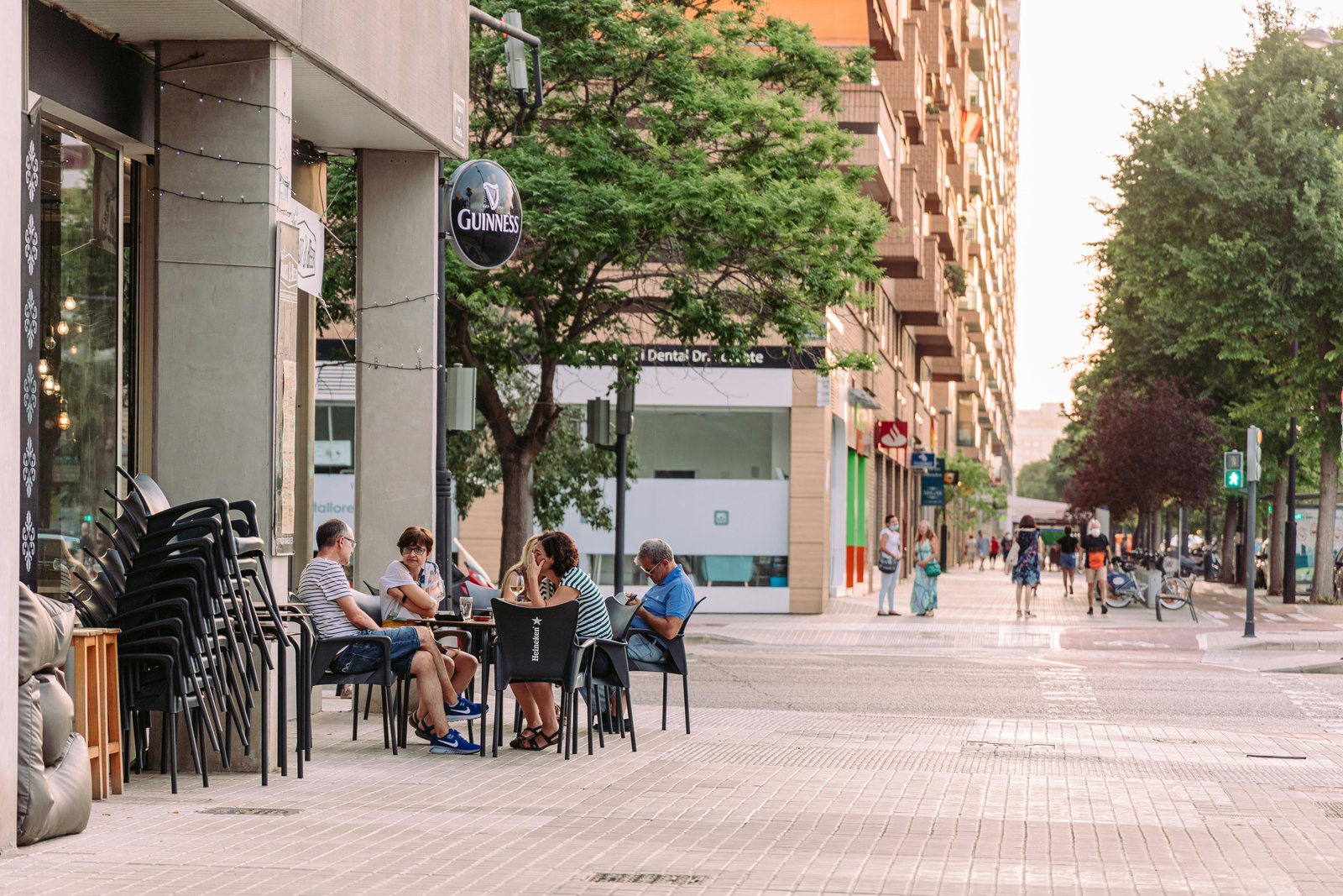 People enjoying a café on a local street, promoting community connection—Buying Local Sustainable and Beneficial.