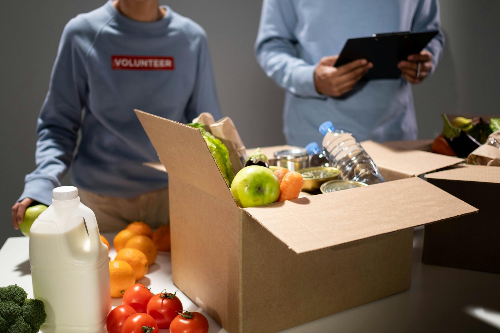 Volunteers packing food boxes to give back to the community.
