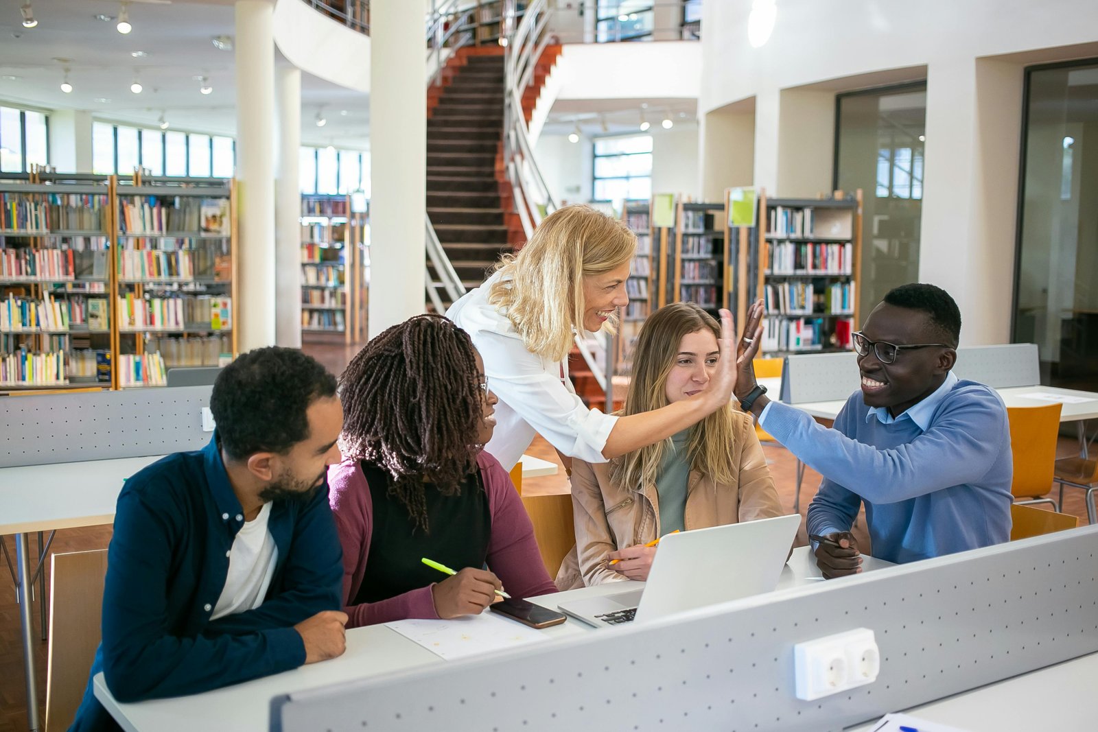 Diverse group of students studying together, discussing Race-Based Admissions.