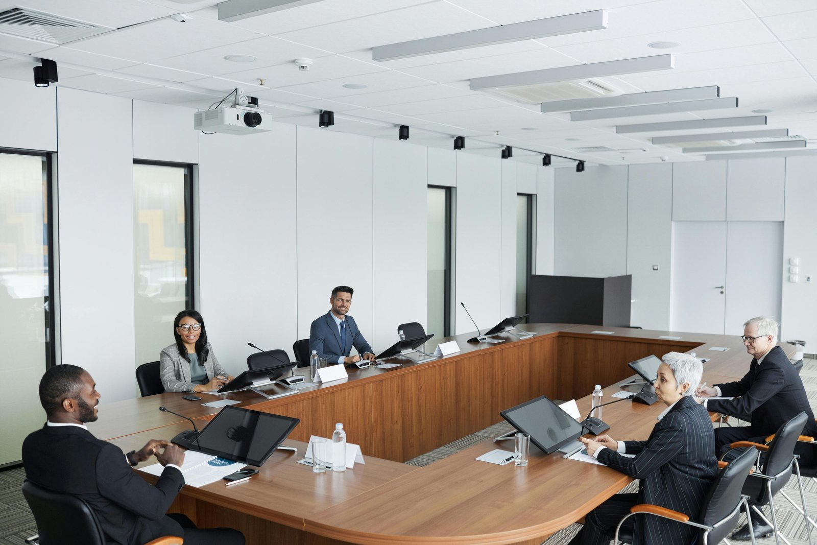 a group of people sitting at a table - The Role of Internal Audit